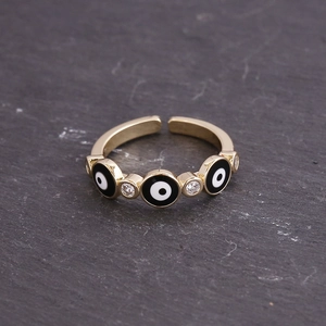Detail view of five evil eye elements with white zircons on a gold-plated adjustable ring