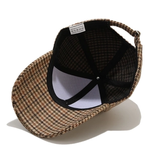 Detailed view of internal washing label and polyester houndstooth texture on baseball cap