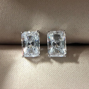 Macro shot of Radiant-cut clear zircon earrings with classic four-prong silver setting