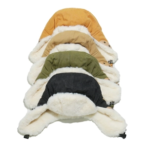 Detailed stack of winter aviator hats in yellow, khaki, green and black with faux fur lining
