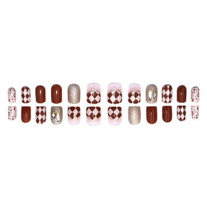Press-on nail set in brown and beige tones with glitter accents and crystal charms