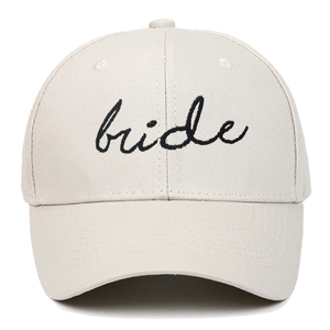 Close-up of black Bride embroidery on cream cotton twill baseball cap with curved brim