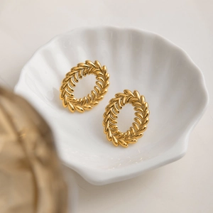 Classic 18K gold plated stainless steel leaf textured oval hoop earrings on a tray