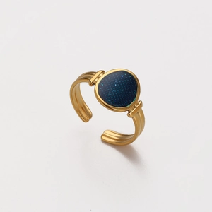 Detailed shot of gold-plated adjustable ring with blue glitter inlay and textured band