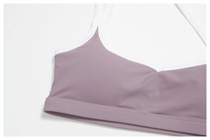 Close-up of lilac sports bra showing high-stretch fabric and white contrast piping