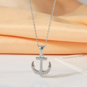Vintage titanium steel anchor necklace with sparkling cubic zirconia on orange silk