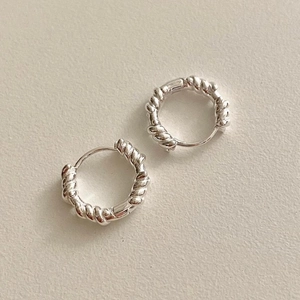 Minimalist twisted rope silver hoop earrings for women shown from a 45-degree angle