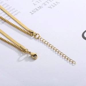 Macro detail of gold layered blade and box chain necklace with adjustable lobster clasp
