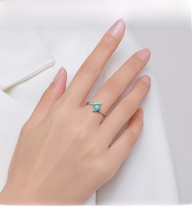 Close-up of S925 silver ring featuring square green gemstone and sparkling side stones