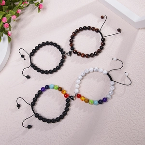 Detail view of magnetic heart clasps and natural stone beads on couple bracelets