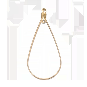 Close-up of golden teardrop earring charm with double rings for DIY jewelry making