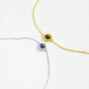 Detail of s925 silver necklaces in gold and silver finish with blue gemstone pendants