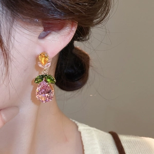 Detailed view of luxury zircon earrings with gold finish and colorful teardrop stones