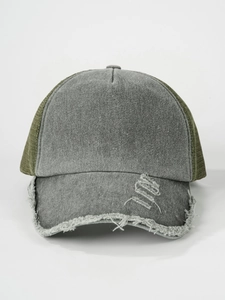 Detail of distressed baseball cap featuring raw edges and green breathable mesh
