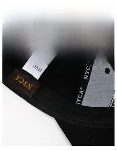 Detail shot of the widened sweatband and inner brand label of a black cotton baseball cap