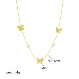 Elegant gold titanium necklace with three white shell butterflies and pearls on white background