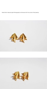 Detailed macro shot of vintage gold irregular pleated metal earrings with artistic texture
