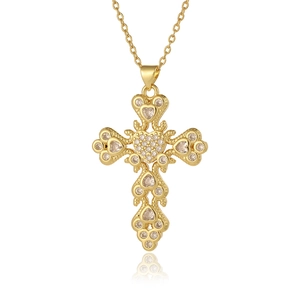 Detailed close-up of a gold cross pendant necklace featuring inlaid heart-shaped cubic zirconia