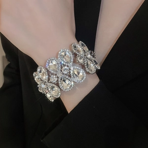 Close-up of luxury wide silver stretch bracelet with sparkling pear-shaped rhinestones