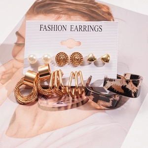 Detail view of 12-piece gold earring set with pearls and leopard acrylic on display card