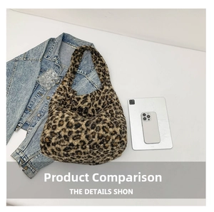 Top view of a large leopard print plush tote bag with denim jacket and gadgets