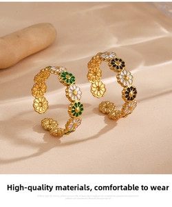 Detail of floral enamel rings in gold finish with adjustable open band design