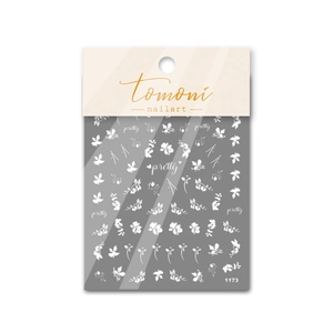 Close-up of white floral and leaf nail stickers on backing card with pretty text