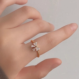 Macro shot of 14K gold plated bow ring with micro-set zircons on a model's finger