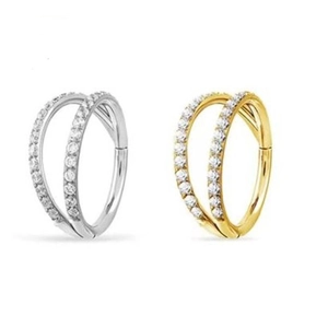 Macro detail of G23 titanium double hoop nose rings with inset crystals in gold and silver