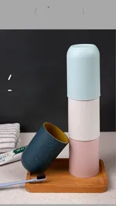 Detail view of a four-color minimalist plastic mouthwash cup set with water droplets