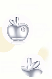 Detail of 925 sterling silver apple stud earring featuring shining cubic zirconia inlay