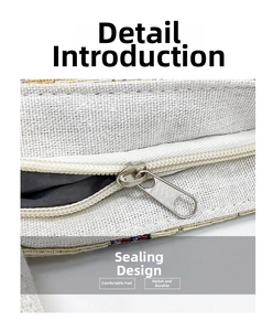 Detailed close-up of a silver metal zipper and coarse texture canvas fabric on a handbag