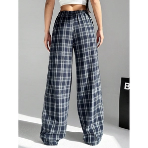 Detail of high-waisted wide-leg pants with black and white plaid pattern and elastic waist