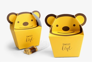 Detail of yellow cartoon bear folding gift boxes for cookies with Sweet Love print