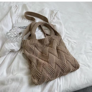 Detailed close-up of khaki knitted tote bag showing 3D crochet weave texture