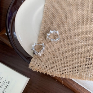 Minimalist 925 sterling silver pleated wave hoop earrings on a vintage aesthetic background