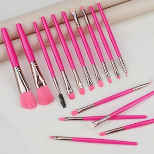 Close-up of 15 professional pink makeup brushes with soft fiber bristles and silver ferrules