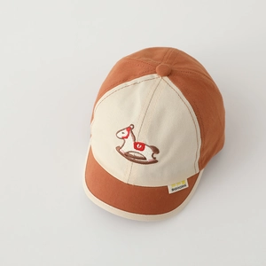 Close-up of children's baseball cap featuring a red pony embroidery and two-tone stitching