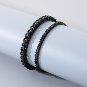 Detail of black stainless steel keel chain bracelets in two sizes on blue display stand