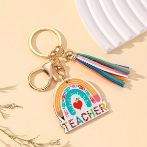 Rainbow teacher keychain with colorful tassel and gold lobster clasp on stone display