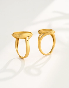Macro detail of two adjustable gold S925 silver oval ring blanks for gemstone inlay