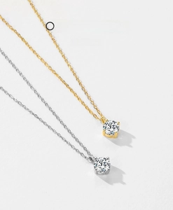Detail of S925 silver single diamond necklaces with four-prong settings in gold and silver