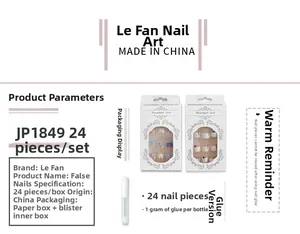 Detailed view of press-on nail kit with geometric orange and green color-block patterns