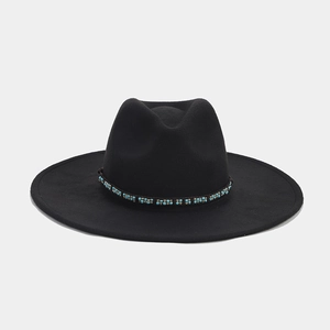 Detail of black wool fedora hat featuring a handmade turquoise and gold beaded band