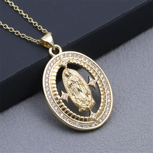 Close-up of golden Virgin Mary pendant with sparkling cubic zirconia on a necklace