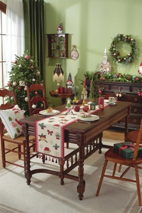 Detailed close-up of a Christmas table runner featuring red tassels and festive patterns