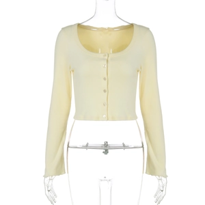 Detail of light yellow knit cardigan featuring fine rib texture and small buttons