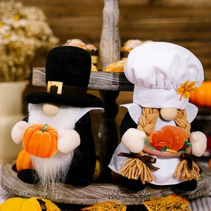 Detail of harvest gnomes with pumpkin and roast turkey on a tiered wooden tray