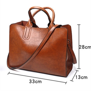 Detailed dimension chart showing a brown leather tote bag measuring 33cm x 13cm x 28cm
