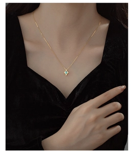 Detail of S925 silver star pendant necklace with blue topaz on a model in velvet